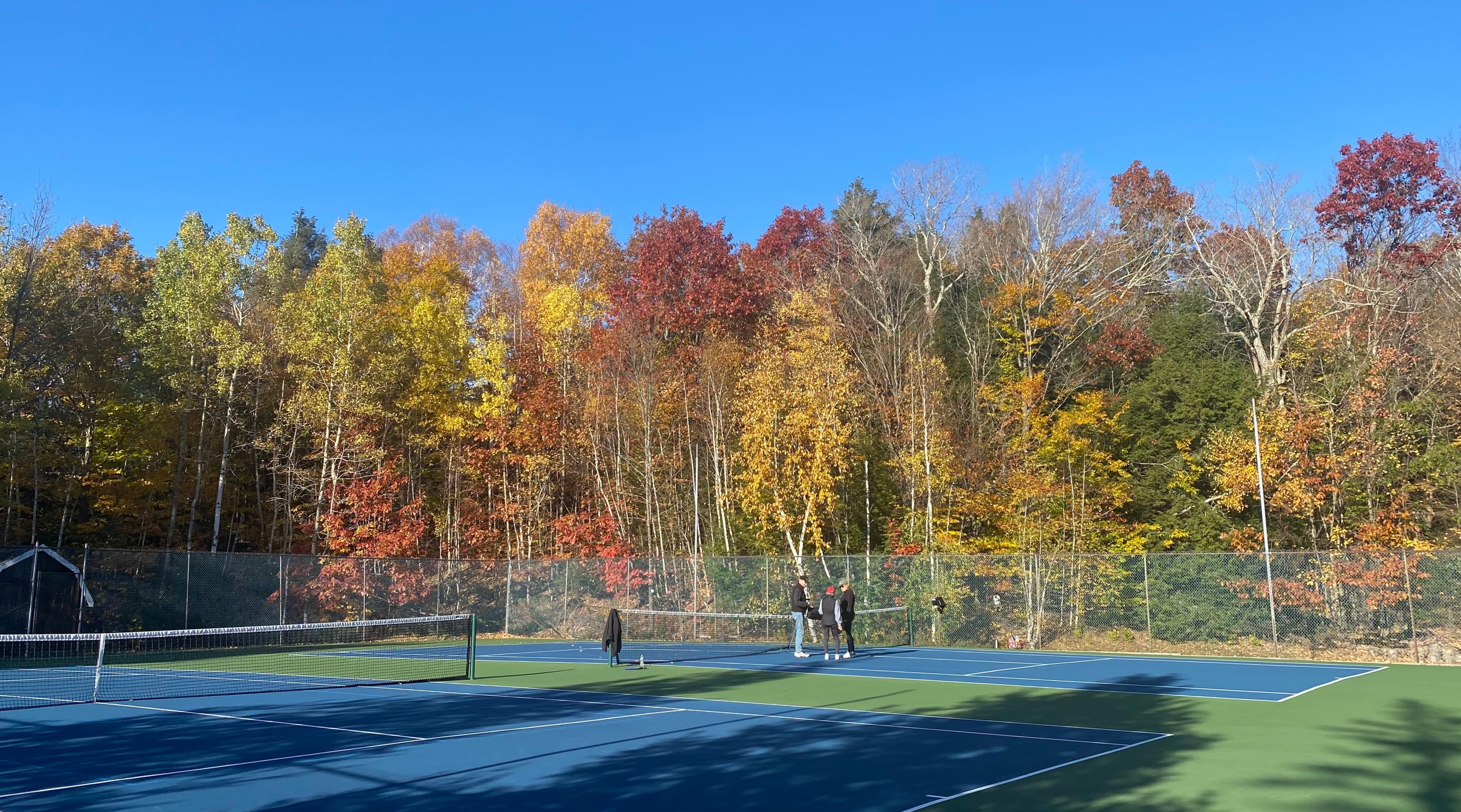 Tennis courts at High Ridge Club with fall foliage
