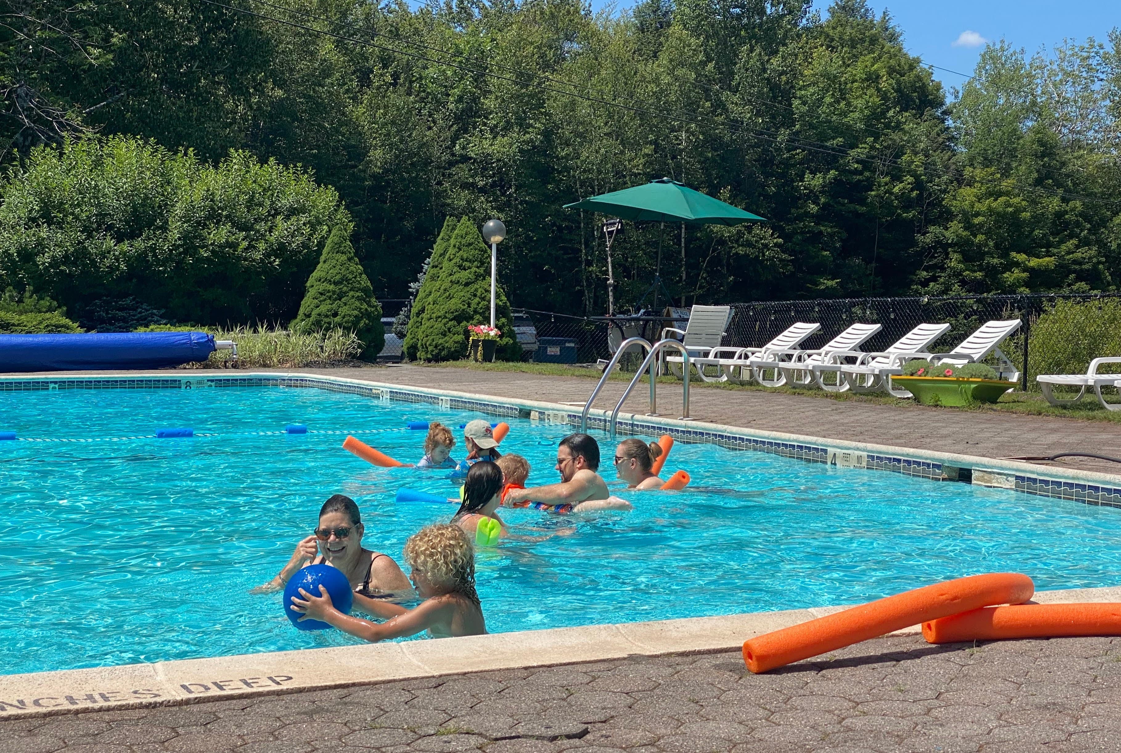Adults enjoying pool activities at High Ridge Club